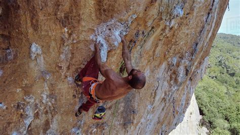 From Above Of Strong Shirtless Bearded Mountaineer Climbing Ascending