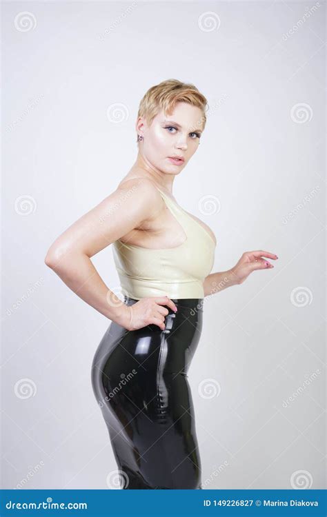 Hot Short Hair Blonde Girl With Curvy Body Wearing Latex Rubber Dress