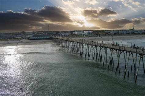 Aerial Shot Of The Kure Beach Pier With Ocean Water Waves People On