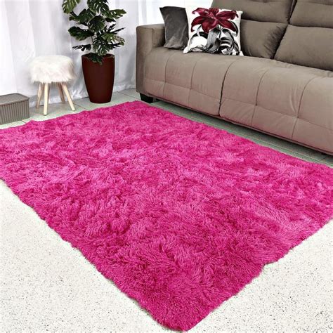 A Living Room With A Couch And Pink Rug