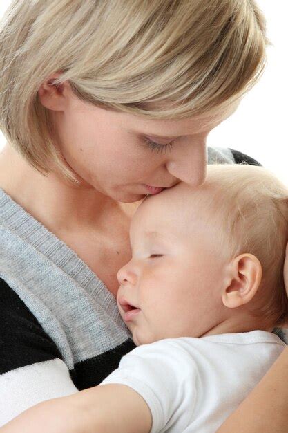 Premium Photo Mother Kissing On Son Forehead Against White Background