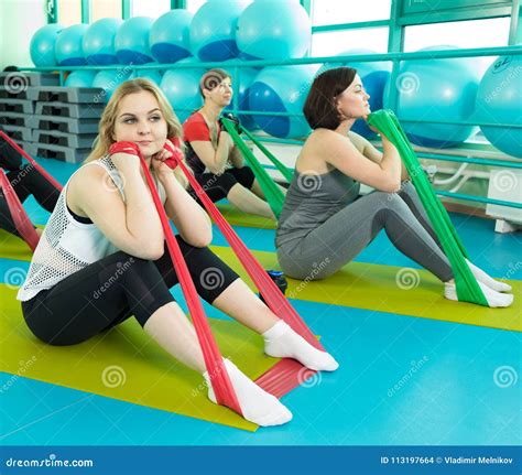 Women Doing Gym Exercises Using Latex Fitness Bands Stock Photo Image