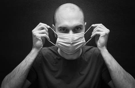 Premium Photo Close Up Portrait Of Man Wearing Mask Against Black