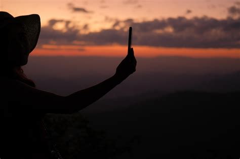 Premium Photo Silhouette Man With Arms Raised Against Sky During Sunset