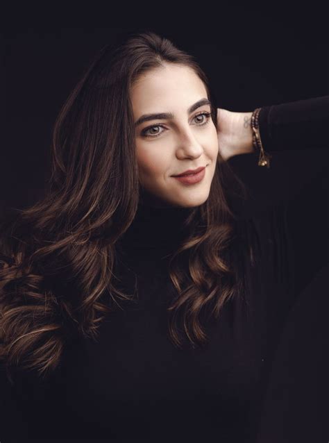 A Woman With Long Hair Posing For A Photo