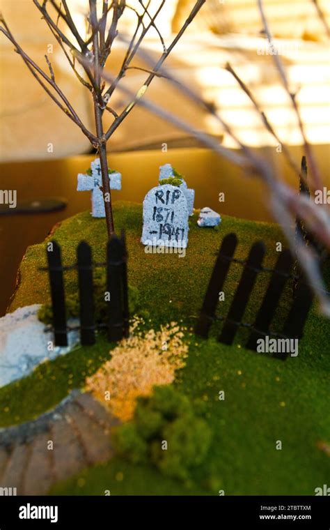 Miniature Graveyard Scene With Focus On Headstone And Fence Stock Photo