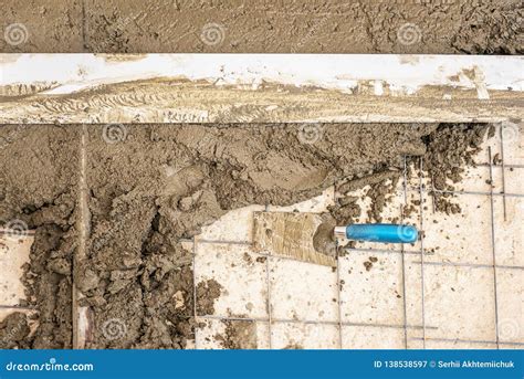 Builder Worker Plastering Concrete At Floor Of House Construction Stock