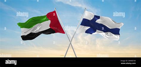 Two Crossed Flags Finland And United Arab Emirates Waving In Wind At