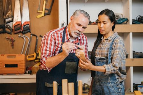 Premium Photo Craftsmen Senior Man Teaching Woman Apprentice At