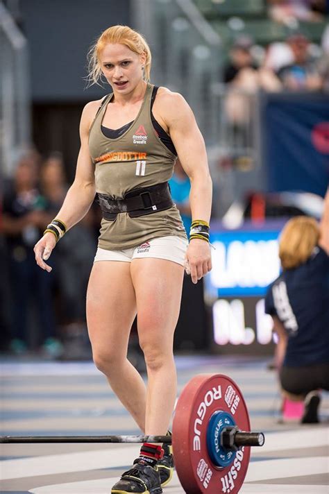 A Woman Standing On Top Of A Barbell