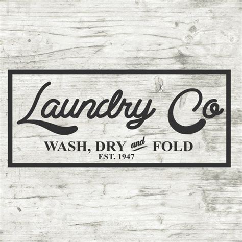 The Logo For Laundry Co Wash Dry And Fold On A Wooden Background With