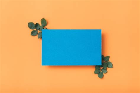 Premium Photo Blue Blank Paper Note Or Card With Green Leaves Decor