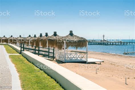 Massage Huts With Thatched Roof On Sand Beach Along Seaside Luxury