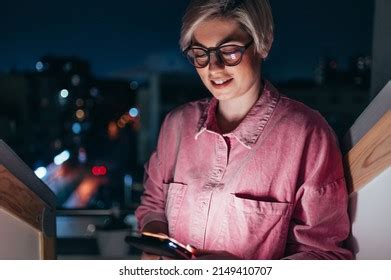 Short Haired Blonde Woman Using Smartphone Stock Photo