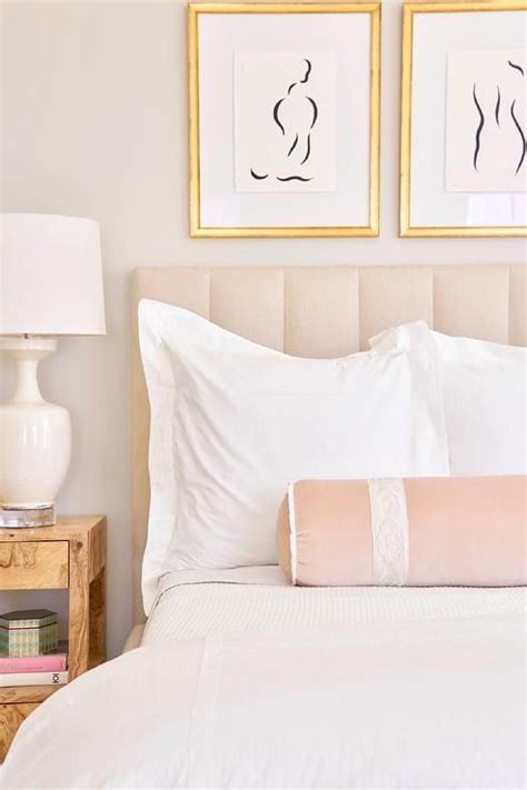 Welcoming Blush Pink Bedroom Features Side By Side Nude Sketches Accented With Gold Leaf Frames