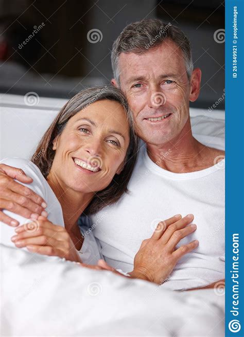 Morning Loving Portrait Of A Loving Mature Couple Cuddling In Bed