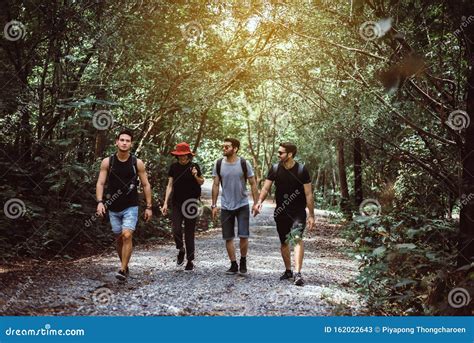 Group Of Traveler Friends Walking Together At Rain Forestenjoying