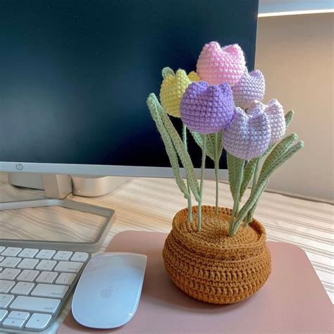 Crocheted Flowers In A Basket Next To A Computer Keyboard