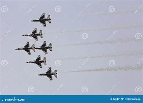 Usaf Thunderbirds Performing A Delta Roll Manuever At An Air Show