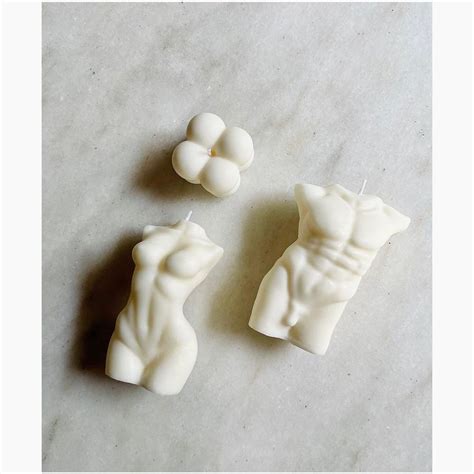 Three Candles That Have Been Made To Look Like The Torsos Of A Man And Woman