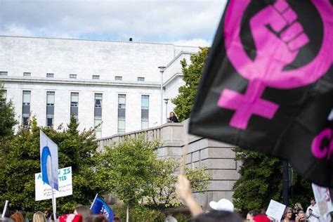 Womens Wave March 2022 Demonstrators Hold Signs During The Womens March