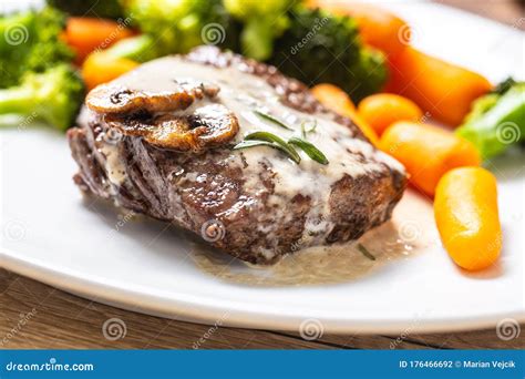 Juicy Beef Rib Eye Steak With Mushroom Sauce And Baby Vegetable Stock