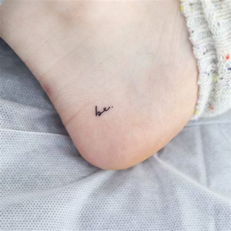 Tattoo of the word "be" located on the foot.