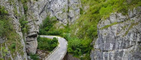 Aerial Drone View Of A Bridge Winding Through The Vertical Stone Walls