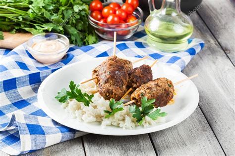 Barbecued kofta with rice on a plate — Stock Photo © fotek #118968262