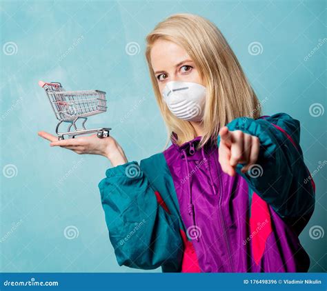 Woman In 90s Clothes And Face Mask With Shopping Cart Stock Photo