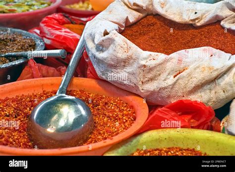 Close Up Of Bags And Bowls Of Chilli Powder Chilli Flakes And Assorted