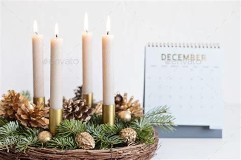 Handmade advent wreath with four candles lit on sundays before xmas Stock Photo by OksaLy