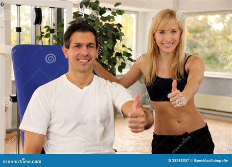 Attractive Blonde Woman And Her Trainer In A Gym Stock Image Image Of Lifting Energy 28385357