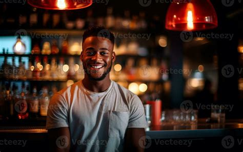 Smiling black bartender relaxing behind the bar. Alcoholic beverage ...