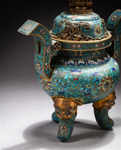 A gilt bronze and cloisonné enamel tripod incense burner and cover