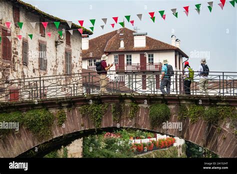 Pilgrims With Backpack Walking The Camino De Santiago Saint Jean Pied