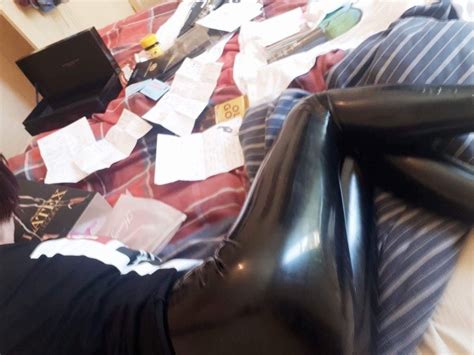 Amateur In Casual Black Latex Leggings And T Shirt On Bed Clothing Items Leather Boots Latex