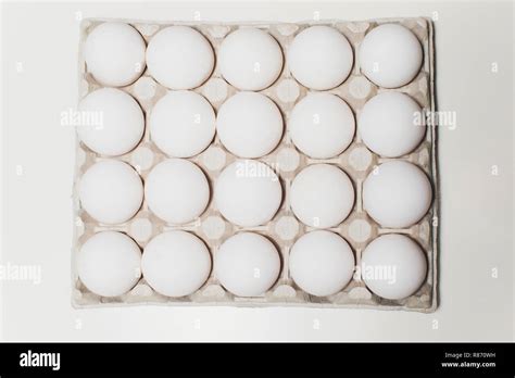 Several white eggs in an egg carton Stock Photo - Alamy