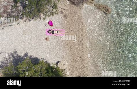 Girl In A Bikini Lies On The Beach Near The Sea Top View Aerial Stock Video Footage Alamy