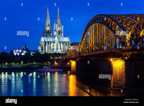 Rhine Bridge And Cathedral Of Cologne Above The River Rhine At Night