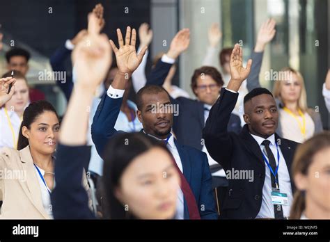 Diverse Business People Asking Question During Speech In Conference