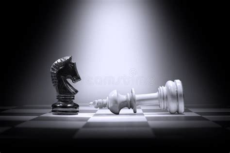 White King Chess Piece Defeating by Black Knight Chess Piece Stock ...