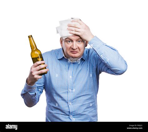 Funny young drunk man holding a beer bottle. Studio shot on white ...