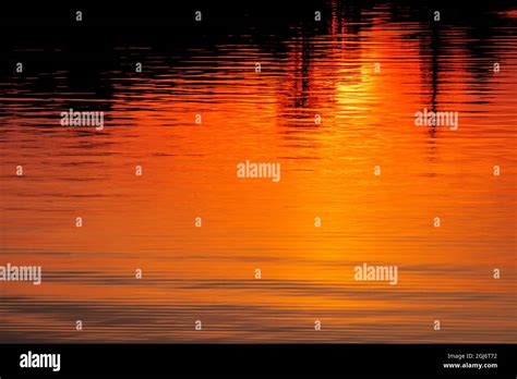 Sunset reflection on lake Stock Photo - Alamy