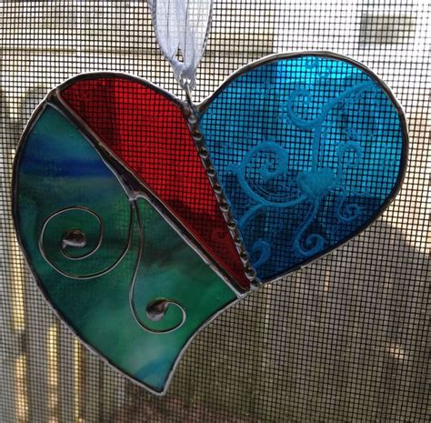 A Stained Glass Heart Hanging On A Window