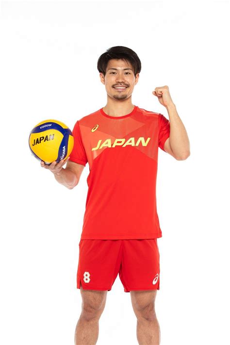 A Man Holding A Yellow And Blue Volleyball