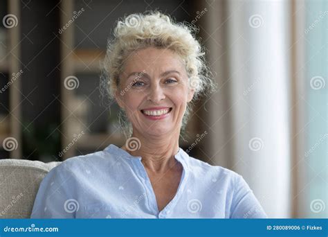 Happy Blonde Mature Woman With Toothy Smile Home Head Shot Stock Photo