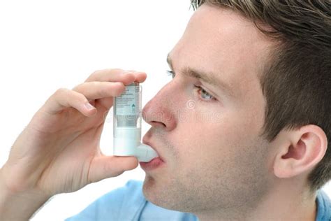 Hombre Joven Que Usa El Inhalador Del Asma Foto De Archivo Imagen De