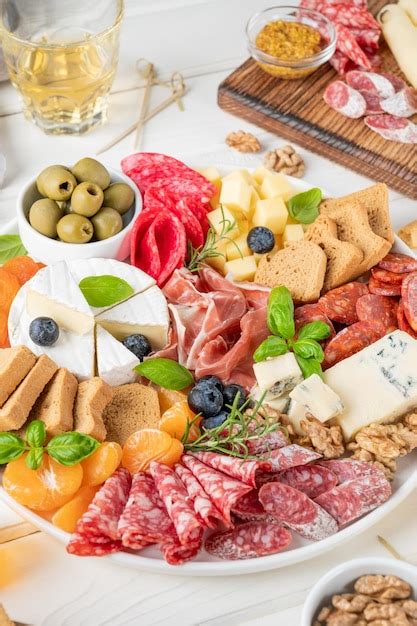 Premium Photo Charcuterie Board With A Variety Of Cheeses Salami Chorizzo Prosciutto Honey