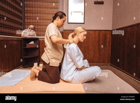 Beautiful Blonde Woman Enjoying Her Shoulder Massage Stock Photo Alamy